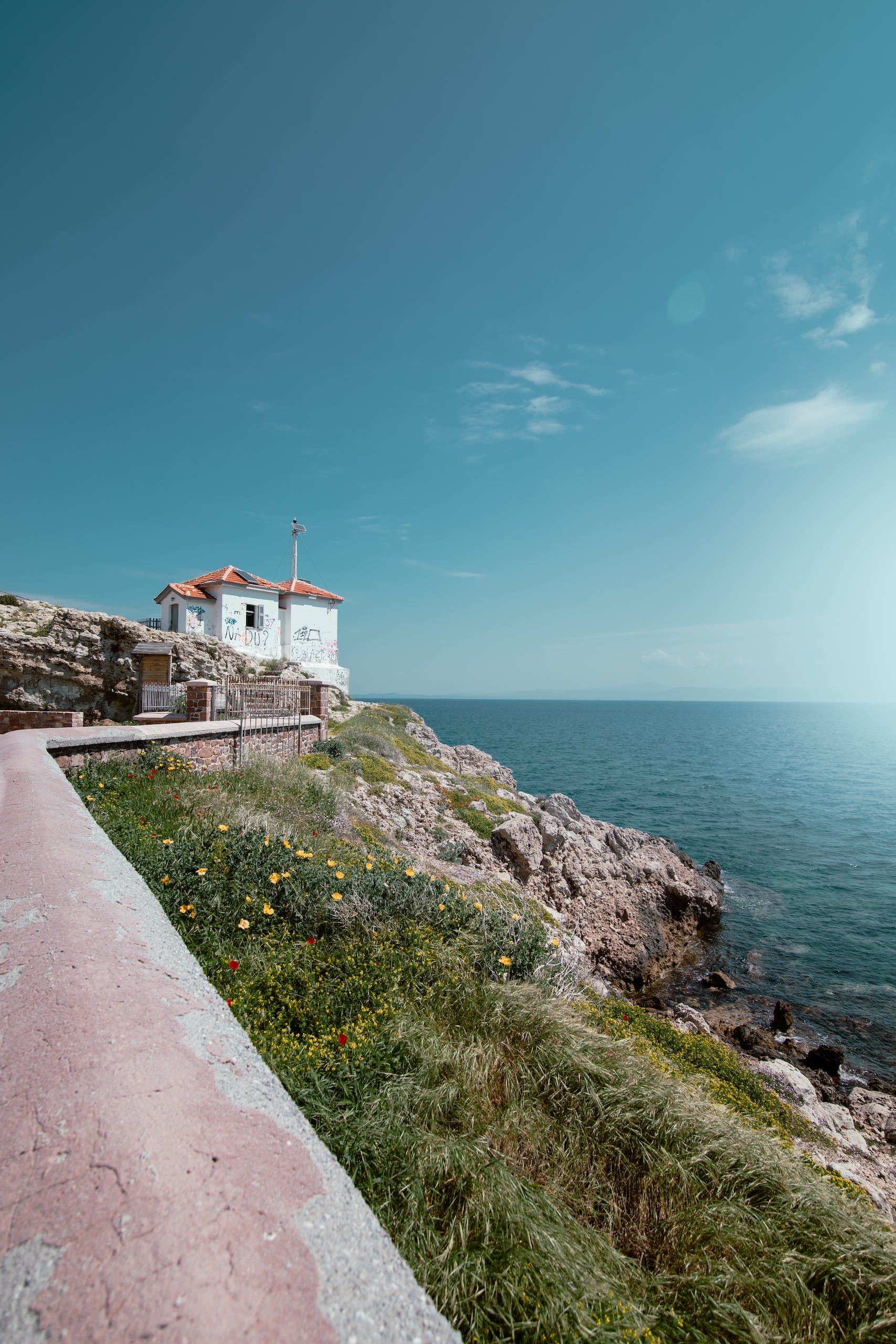 A lighthouse on the coast of a rocky cliff